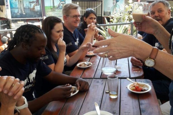 Picture of tourists on Soweto Edutainment tour enjoying a meal