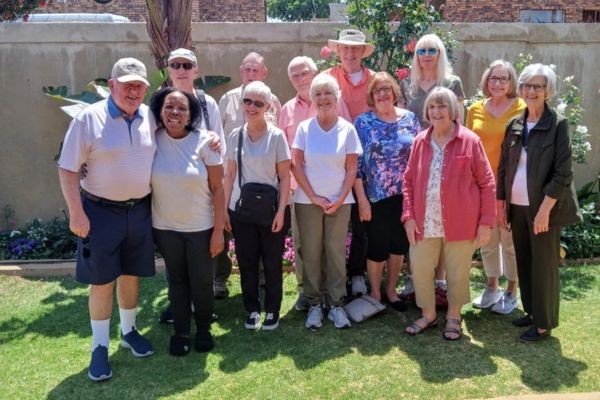 Picture of people in garden of house during Soweto & Lion Park Tour